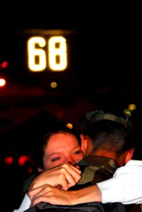 US Navy 070402-N-6326B-085 A sailor comforts his wife before nuclear-powered aircraft carrier USS Nimitz (CVN 68) departs San Diego to begin a scheduled deployment