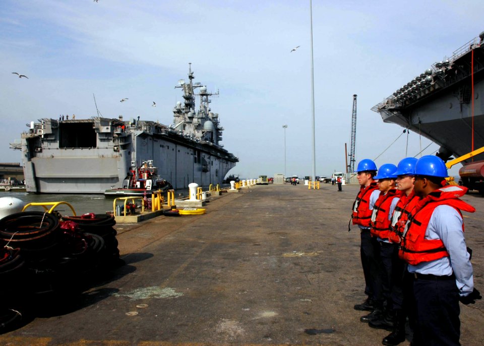 US Navy 070328-N-8547M-010 Sailors stand by as the amphibious assault ship USS Nassau (LHA 4) departs Naval Station Norfolk
