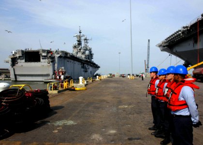 US Navy 070328-N-8547M-010 Sailors stand by as the amphibious assault ship USS Nassau (LHA 4) departs Naval Station Norfolk