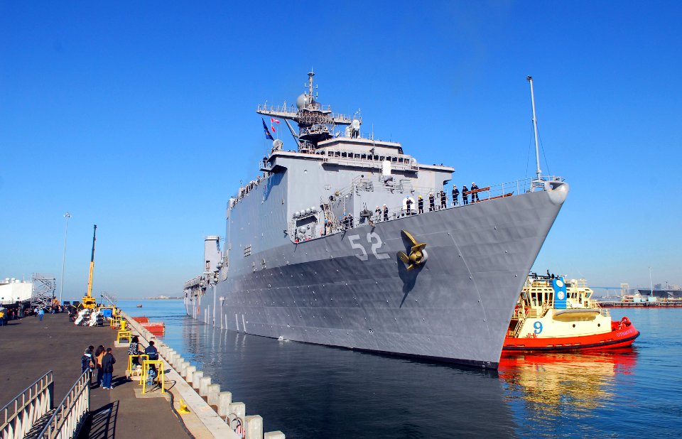 US Navy 070328-N-4776G-398 Dock landing ship USS Pearl Harbor (LSD 52) is pulled away from the pier by a tug at Naval Station San Diego