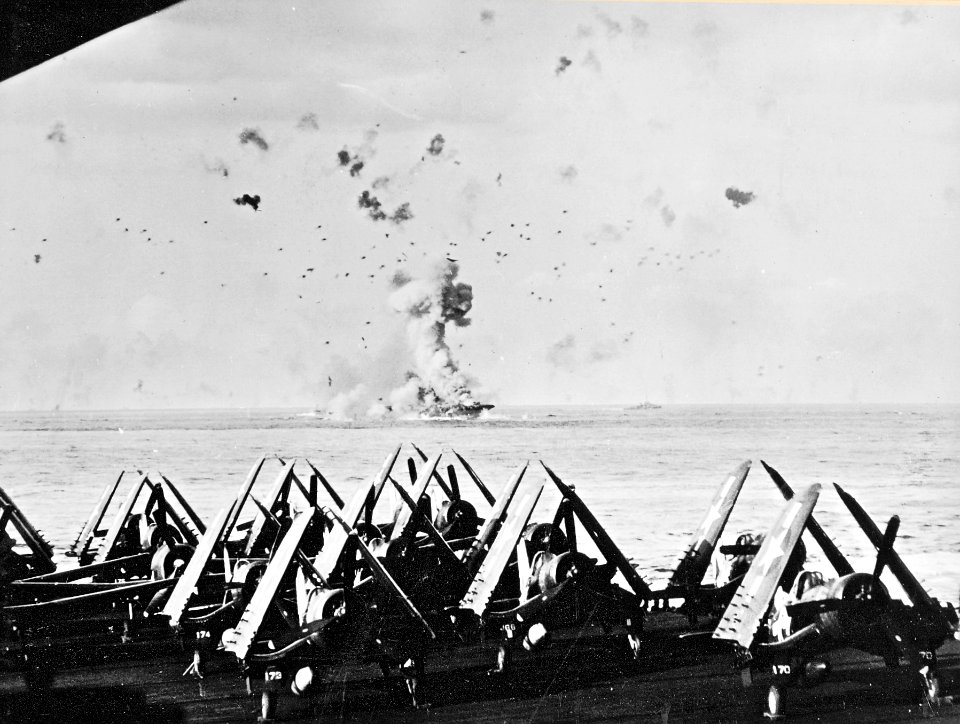 USS Enterprise (CV-6) is hit by kamikaze - seen from USS Essex (CV-9) on 14 May 1945