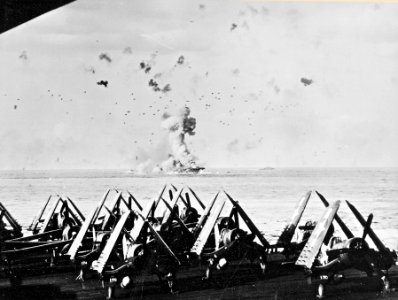 USS Enterprise (CV-6) is hit by kamikaze - seen from USS Essex (CV-9) on 14 May 1945