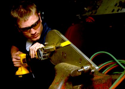 US Navy 070402-N-2908M-002 Hull Technician Fireman Chris Baker removes a part to relocate aboard Nimitz-class aircraft carrier USS Theodore Roosevelt (CVN 71)