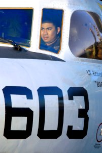 US Navy 070402-N-3659B-067 Engineman 3rd Class Loi Mai, from Vietnam, performs brake rider duties in the pilot seat of an E-2C Hawkeye on the flight deck of Nimitz-class aircraft carrier USS Ronald Reagan (CVN 76)