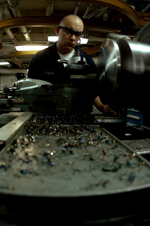 US Navy 070404-N-9760Z-022 Machinery Repairman 3rd Class Seas Yeatman works on fixing a flange aboard the aircraft carrier USS Nimitz (CVN 68)