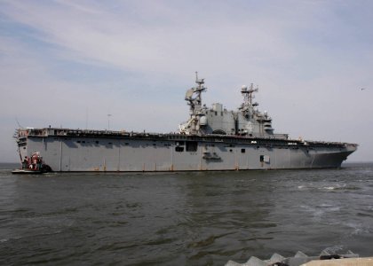 US Navy 070328-N-8547M-022 Tug boats assist the amphibious assault ship USS Nassau (LHA 4) as it departs Naval Station Norfolk