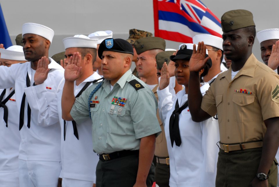 US Navy 070404-N-9909C-004 Sergeant 1st Class Jose Vargas, center, joined 58 Sailors and Marines in taking the oath of citizenship, administered by U.S. Federal District Judge, the Honorable Thomas J. Whelan