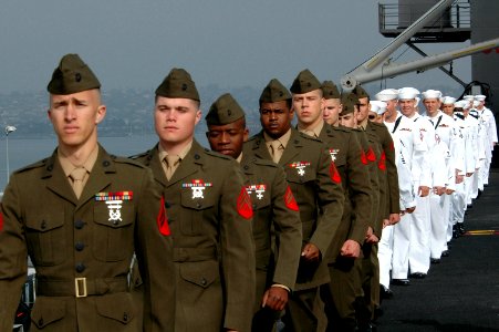 US Navy 070402-N-9760Z-033 Sailors and Marines fall into formation before manning the rails on the flight deck aboard nuclear-powered aircraft carrier USS Nimitz (CVN 68)