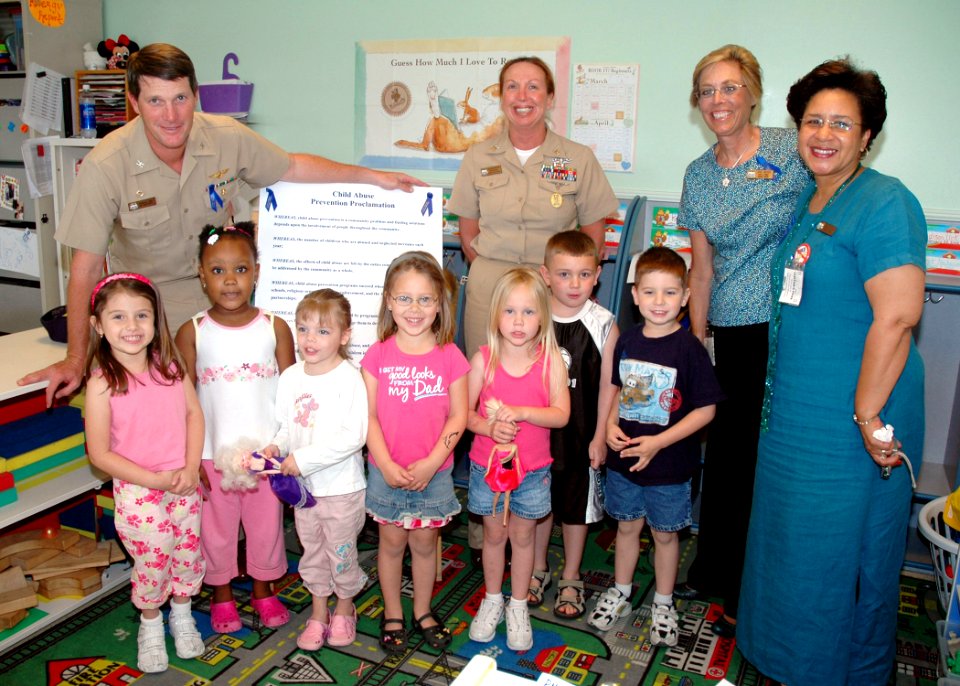 US Navy 070403-N-1522S-003 Capt. Charles King, Command Master Chief (CMDMC) Deborah Davidson, Fleet and Family Support Center Representatives Jaye Meyer and Helen Williams visit the four year old class of the base Child Care De