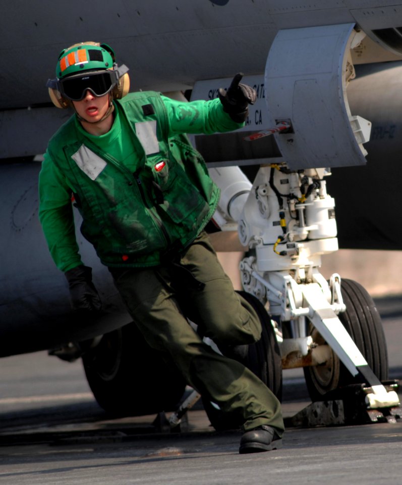 US Navy 070401-N-5345W-083 An aviation boatswain's mate gives the thumbs up to an F-A-18F Super Hornet as it prepares to launch during flight operations on board Nimitz-class aircraft carrier USS Harry S. Truman (CVN 75)