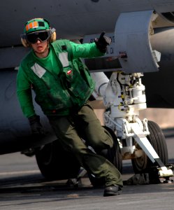 US Navy 070401-N-5345W-083 An aviation boatswain's mate gives the thumbs up to an F-A-18F Super Hornet as it prepares to launch during flight operations on board Nimitz-class aircraft carrier USS Harry S. Truman (CVN 75)