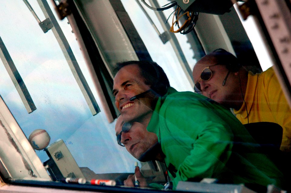 US Navy 070403-N-1635S-001 Capt. Thomas Lalor, left, Cmdr. John A. Breast, center, and Cmdr. James Hineline, right, watch from primary flight control (PRI-FLY) as two F-A-18E Super Hornets fly over the Nimitz-Class aircraft car