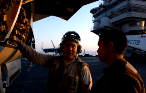 US Navy 070402-N-3659B-136 Aviation Electronics Technician 2nd Class Christopher Scott explains some aircraft inspection procedures to Aviation Machinist's Mate Airman Michael Baluyut