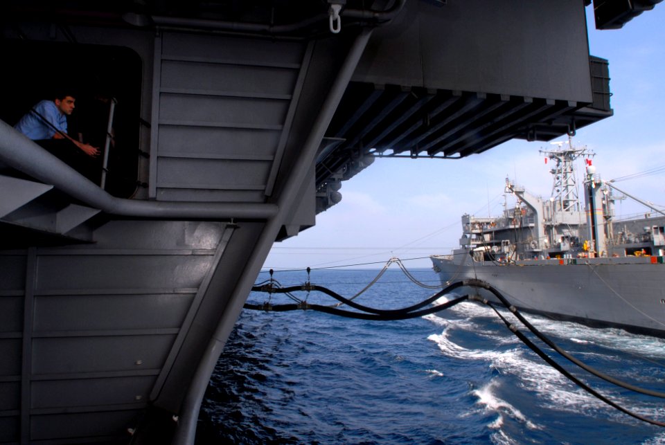 US Navy 070405-N-2659P-175 Electrician's Mate 3rd Class Nathan Wray observes the ongoing replenishment-at-sea (RAS) with the Military Sealift Command (MSC) fast combat support ship USNS Arctic (T-AOE 8)