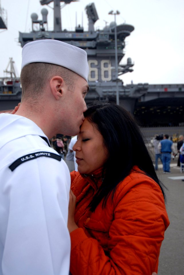 US Navy 070402-N-8273J-082 Aviation Boatswain's Mate (Handling) Airman Colin Navarne says goodbye to his girlfriend prior to nuclear-powered aircraft carrier USS Nimitz (CVN 68) departing Naval Air Station North Island