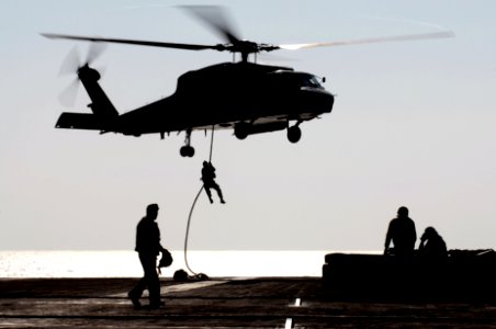 US Navy 070403-N-7130B-194 During an air power demonstration for the crew of USS Ronald Reagan (CVN 76), an SH-60F Seahawk, assigned to the Black Knights of Helicopter Anti-Submarine Squadron (HS) 4, hovers