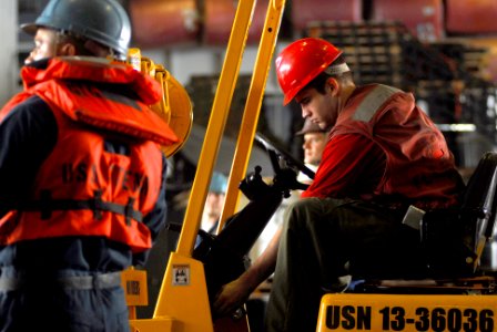 US Navy 070405-N-9928E-059 Aviation Ordananceman Airman Devin Reed prepares his forklift to load pallets in the hangar bay aboard the Nimitz-class aircraft carrier USS John C. Stennis (CVN 74)
