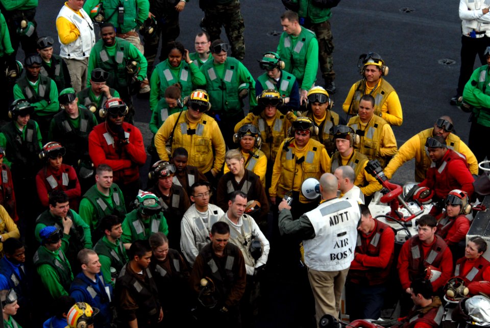 US Navy 070330-N-3659B-104 Lt. j.g. Frank Crouse debriefs flight deck personnel after a successful flight deck drill on board USS Ronald Reagan (CVN 76)