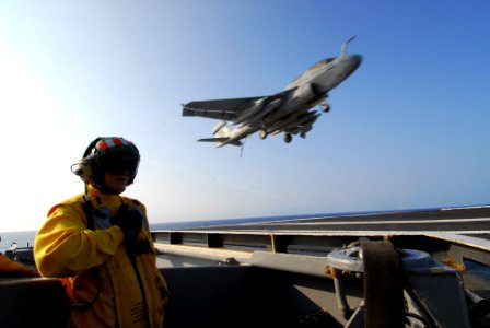 US Navy 070403-N-6326B-086 Arresting Gear Officer, Lt. Sandy Kosloski, supervises the safe recovery of an EA-6B Prowler assigned to Tactical Electronic Squadron (VAQ) 135 on the flight deck of the nuclear-powered aircraft carri