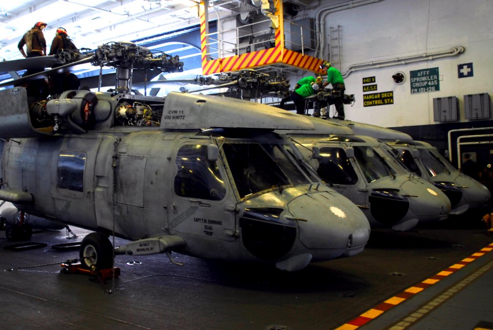 US Navy 070403-N-6326B-032 Sailors assigned to the Indians of Helicopter Anti-Submarine Squadron (HS) 6 perform inspections on the rotor heads of an SH-60 Seahawk in the hangar bay of nuclear-powered USS Nimitz (CVN 68)