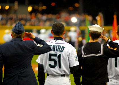 US Navy 070403-N-7981E-078 Major League Seattle Mariner Suzuki Ichiro joins honored service members from the U.S. Air Force and U.S. Navy in saluting the flag for the National Anthem