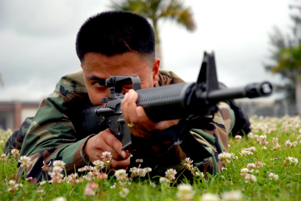 US Navy 070404-N-0775Y-021 Ship Serviceman 1st Class Ronald Umali, attached to Naval Mobile Construction Battalion (NMCB) 3 takes aim with an M-16 rifle during a weapons training course at Camp Shields