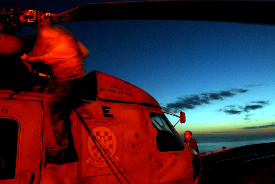 US Navy 070406-N-4133B-130 Seattle native Airman Brian Oldham, assigned to Helicopter Anti-submarine Warfare Squadron Four (HS) 4, holds down the dog house of an SH-60F Seahawk for a daily inspection