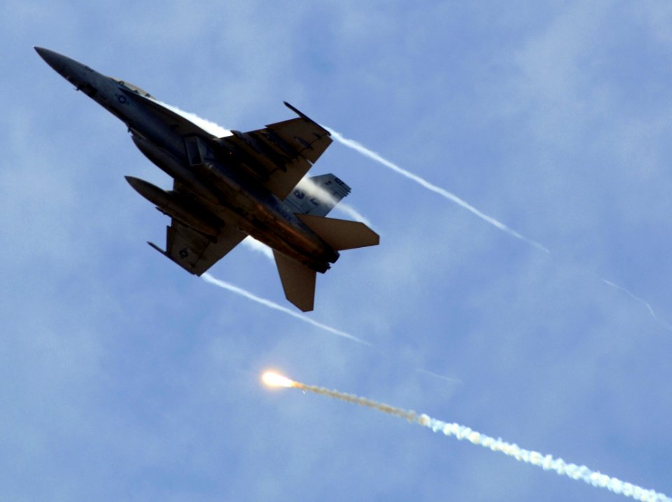 US Navy 070406-N-5345W-215 An F-A-18F Super Hornet, from the Red Rippers of Strike Fighter Squadron Eleven (VFA) 11, fires off its flares while performing evasive maneuvers during an air power demonstration