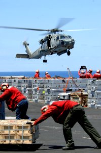 US Navy 070406-N-5961C-001 Members of Ronald Reagan's Weapons Department work with helicopters from Helicopter Anti-Submarine Squadron (HS) 4 during it's weapons offload