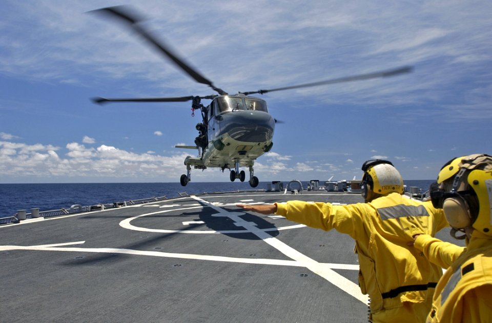 US Navy 070404-N-5459S-061 A Landing Signal Enlisted (LSE) assigned to the guided missile destroyer USS Mahan (DDG 72) guides a Lynx helicopter from the Dutch Navy during a Deck Landing Qualification