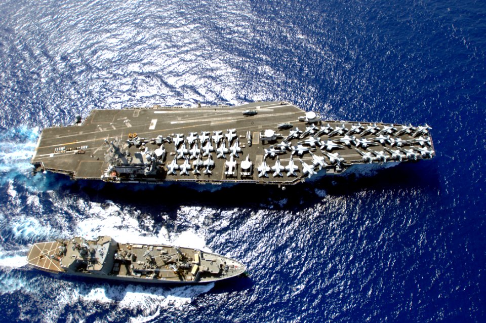 US Navy 070406-N-5961C-008 Nimitz-class aircraft carrier USS Ronald Reagan (CVN 76) works with Military Sealift Command (MSC) ammunition ship USNS Flint (T-AE 32) as the aircraft carrier unloads all of her weapons