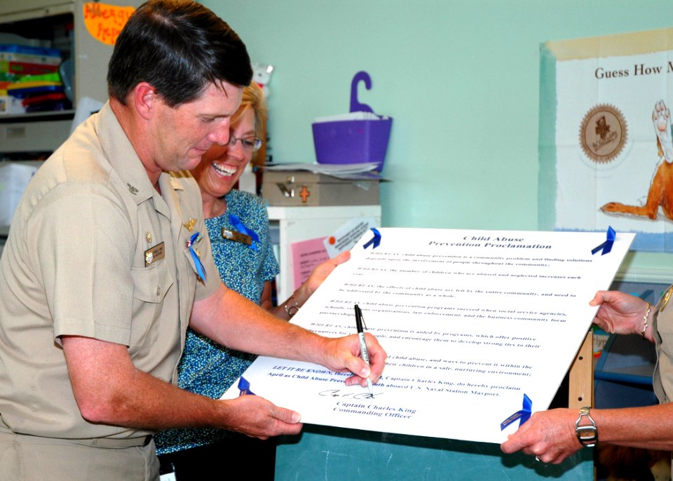 US Navy 070403-N-1522S-002 Commanding Officer, Naval Station Mayport, Capt. Charles King signs a Child Abuse Prevention Proclamation at the base Child Care Development Center