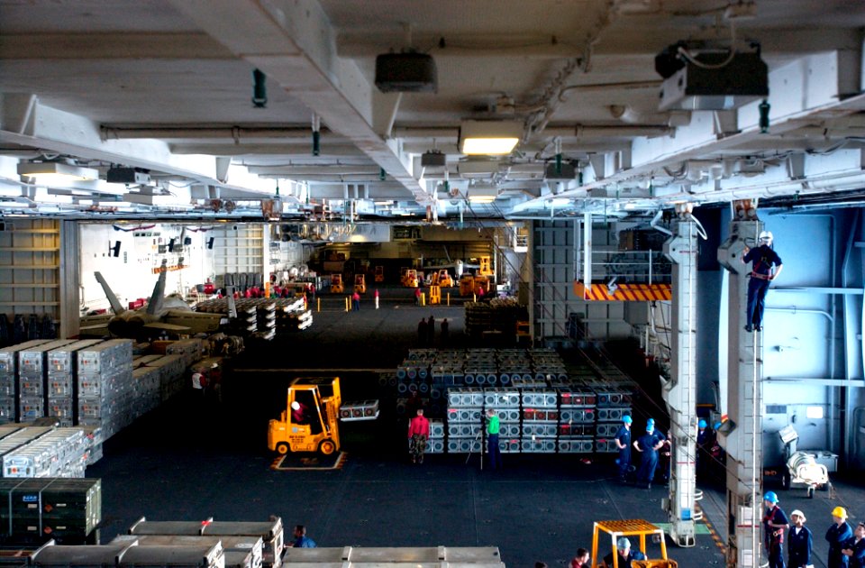 US Navy 070405-N-9712C-001 The hangar bay of the aircraft carrier USS Ronald Reagan (CVN 76) fills with bombs, missiles, and small arms ammunition