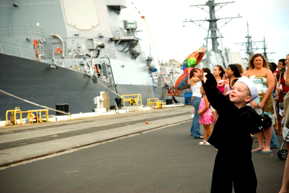 US Navy 070407-N-4856G-034 A little boy waves to his father as families of Sailors stationed aboard guided missile destroyer USS Russell (DDG 59) wait patiently as the ship returns to Naval Station Pearl Harbor