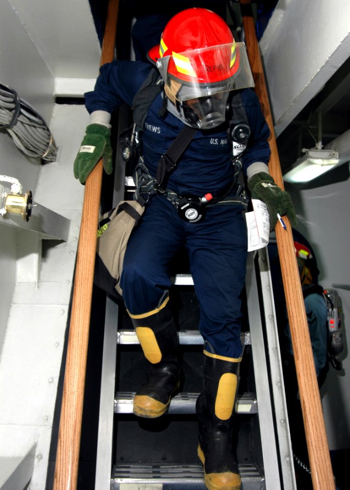 US Navy 070404-N-2910W-066 Yeoman Seaman Ernest P. Matthews descends a ladder-well after securing all spaces on the fantail of the Nimitz-Class aircraft carrier USS Abraham Lincoln (CVN-72) during General Quarters (GQ) drills