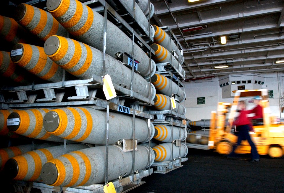 US Navy 070405-N-9712C-003 Using forklifts, aviation ordnancemen stage ammunition in the hangar bay aboard the aircraft carrier USS Ronald Reagan (CVN 76)