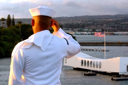 US Navy 070409-N-1635S-002 A Sailor salutes the USS Arizona Memorial from the flight deck of USS Ronald Reagan (CVN 76) as they pull into Pearl Harbor, Hawaii photo