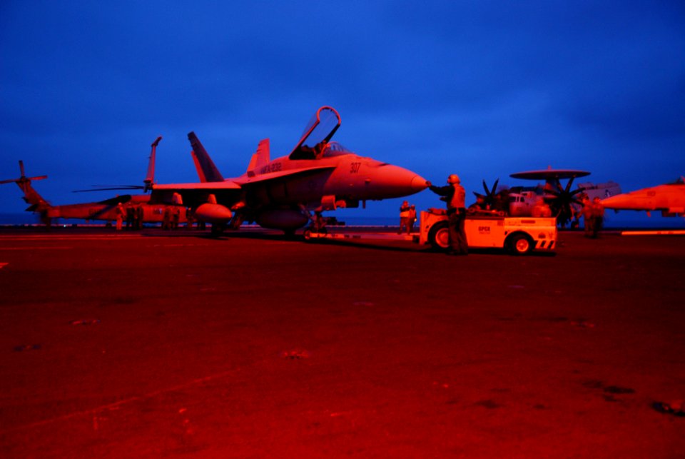 US Navy 070404-N-6326B-003 U.S. Marines assigned to the Red Devils of Marine Fighter Attack Squadron (VMFA) 232 move an F-A-18A Hornet