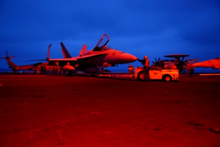 US Navy 070404-N-6326B-003 U.S. Marines assigned to the Red Devils of Marine Fighter Attack Squadron (VMFA) 232 move an F-A-18A Hornet