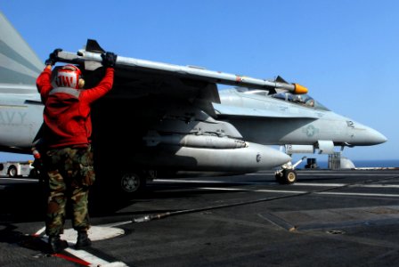 US Navy 070406-N-2659P-014 An aviation ordnanceman, from the Black Knights of Strike Fighter Squadron (VFA) 154, checks to ensure the AIM-9 missile is secure on an F-A-18F Super Hornet