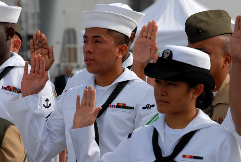 US Navy 070404-N-9909C-010 Sailors and Marines take the oath of citizenship during a ceremony held aboard the amphibious transport dock ship USS Cleveland (LPD 7) in San Diego