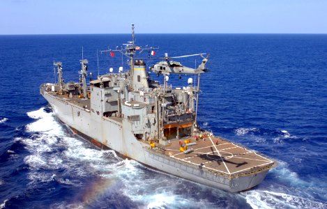 US Navy 070406-N-5961C-009 A helicopter assigned to the Black Knights of Helicopter Antisubmarine Squadron (HS) 4 clears the flight deck of the Military Sealift Command (MSC) ammunition ship USNS Flint (T-AE 32)