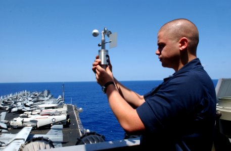 US Navy 070406-N-4009P-149 Aerographer's Mate 3rd Class Heath Collins, from Kirbyville, Texas, uses an anemometer to take a reading of the current local wind speed and direction on board Nimitz-class aircraft carrier USS