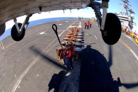 US Navy 070406-N-5961C-013 Members of Nimitz-class aircraft carrier USS Ronald Reagan (CVN 76) Battle E winning weapons department prepare to attach a cargo pendant to a SH-60 photo