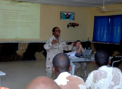 US Navy 070407-N-1003P-002 Navy Lt. Tahmika Jackson, assistant Staff Judge Advocate, discusses the Soldiers Third Rule to 52 members of the Rapid Action Regiment and Presidential Republican Guard during human rights training photo