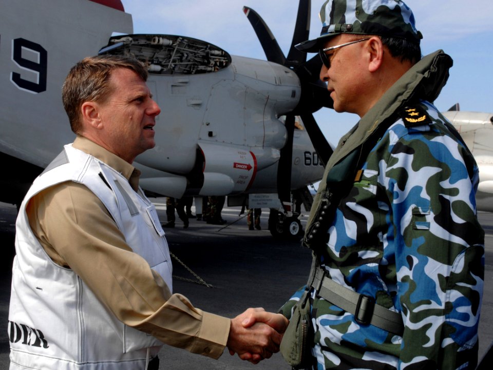 US Navy 070406-N-5345W-006 Commander, Carrier Strike Group (CSG) 10 Rear Adm. William Gortney welcomes Chinese People's Liberation Army Navy (PLAN) Vice Adm. Wu Shengli after arriving aboard the Nimitz-class aircraft carrier US