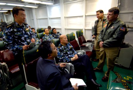 US Navy 070406-N-5345W-339 Commander, Carrier Strike Group (CSG) 10 Rear Adm. William Gortney fields a question from Chinese People's Liberation Army Navy (PLAN) Lt. Sun Jian after a carrier-based aviation briefing in Strike Fi