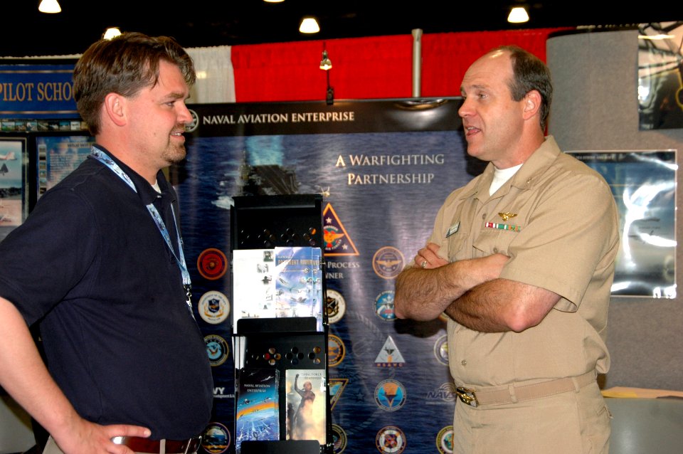 US Navy 070411-N-4047W-020 Cmdr. Jack Hanzlick and Exhibitor Rick Tarr discuss the Naval Aviation Enterprise at the Annual Naval Helicopter Association Symposium Exhibition