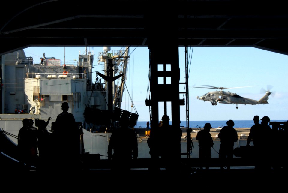 US Navy 070406-N-3659B-042 Deck Department personnel and aviation ordnancemen transfer ammunition to the Military Sealift Command (MSC) ammunition ship USNS Flint (T-AE 32) during an ordnance offload evolution