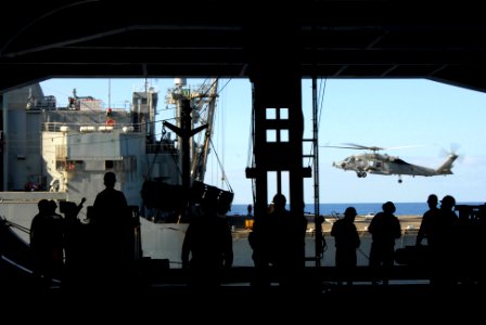 US Navy 070406-N-3659B-042 Deck Department personnel and aviation ordnancemen transfer ammunition to the Military Sealift Command (MSC) ammunition ship USNS Flint (T-AE 32) during an ordnance offload evolution